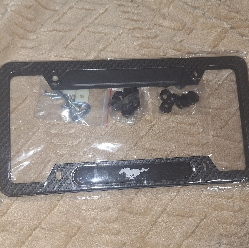 Ford MUSTANG Carbon Fiber License Plate Frame with The Ford Mustang On It.